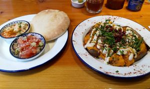 Sweet potato with tahini, pomegranate, nuts, hummus & pita bread at Chickpea in Antwerpen