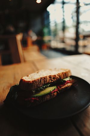 Beetroot hummus, avocado, tomato & rocket sandwich on sourdough  at MOTHER - Juice Works in East London