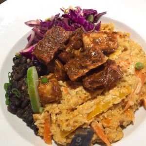 Dinner special, vegan option, by Chef Chris at Nine Mile West: Jerk tofu over a sauté of peppers, carrots, and mango tossed with rice in a red curry coconut sauce; served with black beans and a currant-apple slaw. at Nine Mile West in Asheville