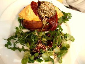 Baked sweet potato with humus, sundried tomatoes, pesto and rocket at Picnic in Glasgow