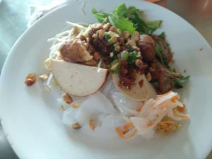 The topping is fried spring rolls, vegan sausage, vegan grilled mock meat and pickles at Tinh Duyen in Long Xuyen