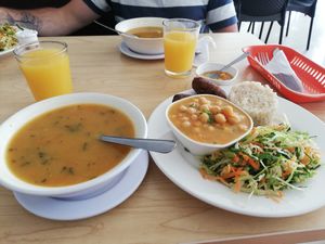 Soup, and the main dish with chickpea curry, rice, salad and quibes at Semillas de Albahaca in Tunja