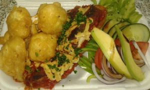 Oven Baked Zucchini Halves with a Delicious Vegan Mince Filling Topped with Vegan Cheese served with Battered Crisp Fried Cauliflower and Salad at Vegan To Order in Windhoek