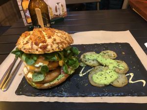 The bun has cheese on it but it can be ordered without.  at Sanissimo - Principe Pio in Madrid