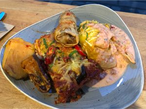 Lasagna, enchiladas, potatoes and spring roll. So good. So much food!!  at Nordvegan in Oslo