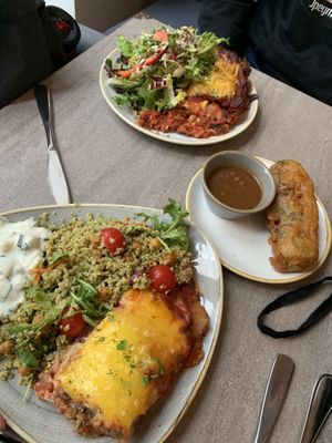 Mains with salad and topping and a summer roll on the side at Nordvegan in Oslo