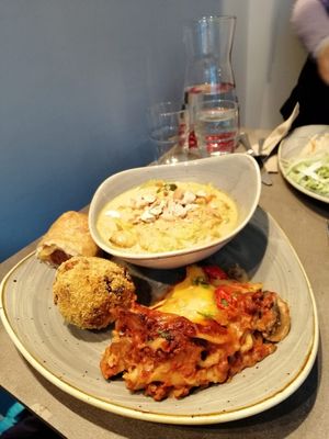 Curry, lasagna and "quick bites" sausage roll and a rice ball at Nordvegan in Oslo