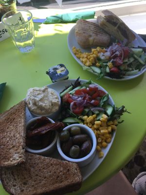 Toast with hummus, sundried tomatoes & olives and vegan toastie with cheese and bacon   at Musicker in Isle Of Bute