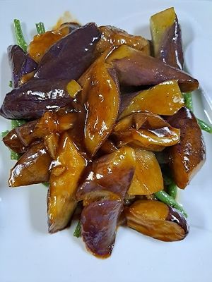 -Sauteed Eggplant in Basil Garlic Sauce on bed of String Beans.
 at Ginger Root in New York City