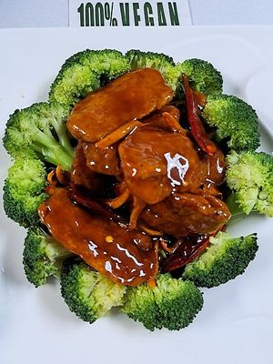 -Orange Seitan Breaded Medallions of Wheat Protein Sauteed in a Spicy Citrus Sauce, over a bed of Broccoli. at Ginger Root in New York City