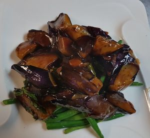 Sauteed eggplant in basil garlic sauce on a bed of string beans. at Ginger Root in New York City