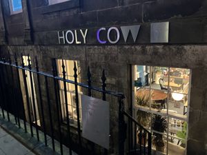Easy to miss - the entrance is down some stairs and is in a basement shop.  at Holy Cow in Edinburgh