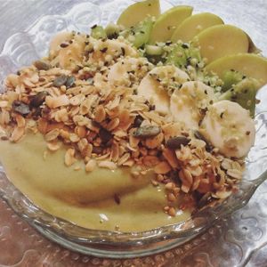 Our Green Deli bowl is both healthy and delicious. Wheatgrass, banana  and apple  topped with seasonal fruit, made-in-house vegan granola and hempseeds at Itacate in Barcelona