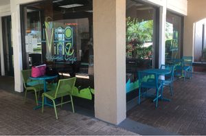 Outdoor seating next to small garden. at Living Vine Organic Cafe in Fort Myers