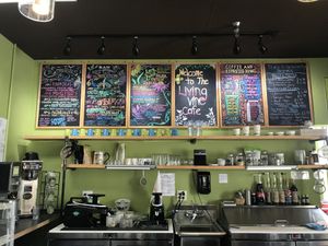 The menu is so cute! Right over the smoothie & coffee station where you order at. Shows the smoothie, protein shake, coffee, and tea selection. at Living Vine Organic Cafe in Fort Myers