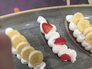 Vegan sweet - crispy toast, hazelnut spread, whip cream & sliced fruit at Pappare' in Bologna