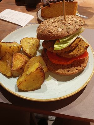 The burger was fine, but the roasted potatoes were amazing! at Pappare' in Bologna