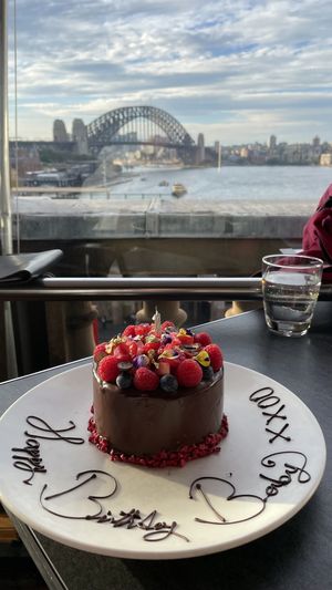 The extremely tasty Vegan birthday mud cake with fresh berries, edible flowers & gold leaf  at Cafe Sydney in Sydney