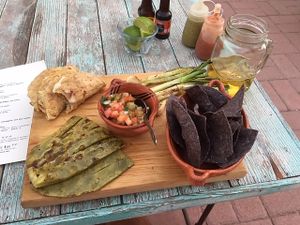 Appetizer with selection of food including small potato enchiladas, cactus, and pico de gallo at La Rana Vegana in Cabo San Lucas
