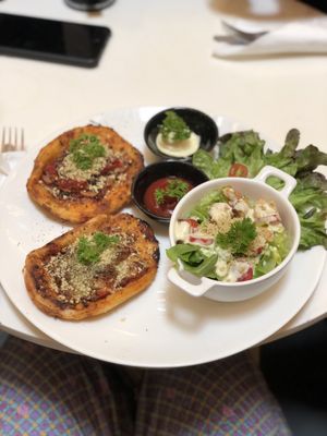 Pizza with vegan sausage and parmesan and side of ceaser salad at Veganerie - Siam Paragon in Bangkok