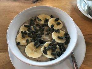 Chia seed porridge with banana and pumpkin seeds at Ahimsa The Vegan Cafe in North West London