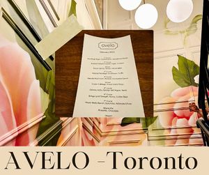 Menu and restaurant wall  at Avelo in Toronto