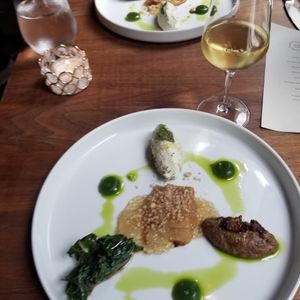 Main, onions surrounded with porcini, almonds, and greens at Avelo in Toronto