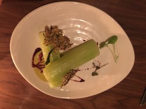 Lettuce stem with zucchini cracker and some kind of sauce at Avelo in Toronto