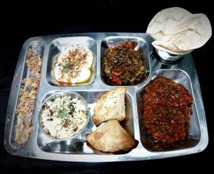 Thali with hummus, seitan and soya baked vegetables, cous cous, samosa, dal makhani and pita bread. at Teteria India in Barcelona
