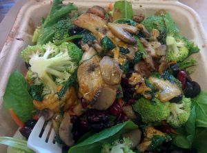 Spinach mushrooms (spinach, mushrooms, marinara, cabbage, mozarella) on an organic salad base (kale, broccoli, salad greens, cranberries, pinenuts, onions). So good! at The Veg Hub in Oakland