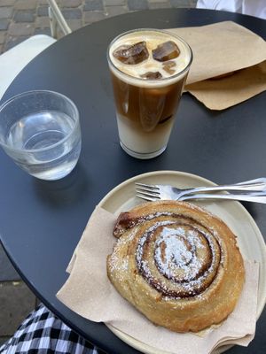 Iced oat latte, vegan cinnamon roll  at Mok in Brussels