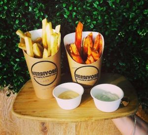 Hand cut potato or sweet potato fries, add our home made chilli mayor garlic aioli, treat yourself! at Herbivore Eatery in South Yarra