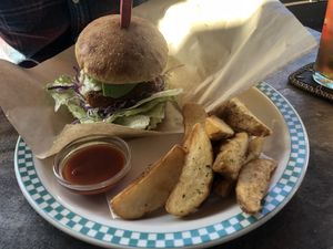 vegan fish burger with avocado and french fries at Rockers Cafe in Yomitan
