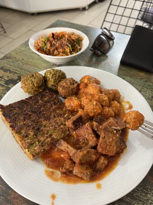 Bulgur salad, zucchini patty, Seiten, falafel, and some Turkish balls of some sort in sauce.   at Vegan Istanbul in Istanbul