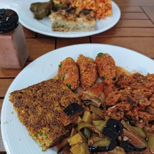 Well cooked eggplant and potato dish, mücver (Turkish zucchini fritter), börek, manti... at Vegan Istanbul in Istanbul