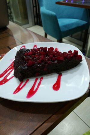 Chocolate cake topped with berries at Vegan Istanbul in Istanbul