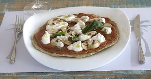 New raw food pizza with mushrooms at HappyRaw Natural Restaurant in Faenza