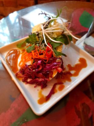 Salad:
- Leafy greens, marinated cabbage with masala, carrot strands with herbs, mustard and honeydew dressing, bean sprouts and banana chutney at Mantra Gastronomia e Arte in Porto Alegre