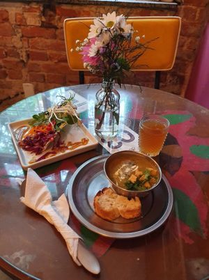 Pea cream,  Coconut bread with coriander seeds, Leafy greens, marinated cabbage with masala, carrot strands with herbs, mustard and honeydew dressing, bean sprouts,  banana chutney at Mantra Gastronomia e Arte in Porto Alegre