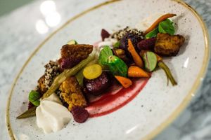 Tempeh served with roasted vegetables and a spicy raspberry sauce at Alive in Vilnius