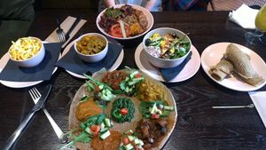 Mains: Wild rice bowl, Injera (with extra Injera); sides: Cole slaw, masala veggies, side salad at Mooshka in Amsterdam