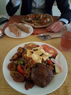 In front Fried rice with veggies. In the back Injera. at Mooshka in Amsterdam
