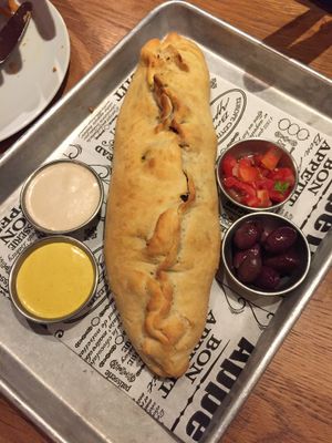 Shwarma in a fresh baked crust with sauces and olives at Four One Six (416) in Tel Aviv