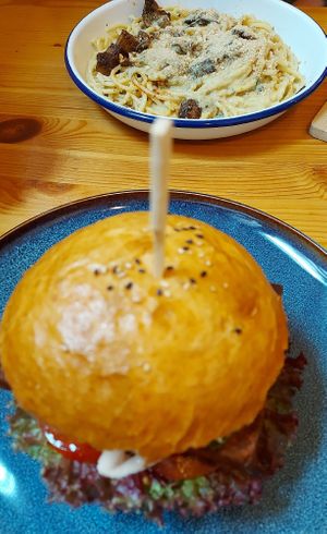 Burger with smoked tofu and dish of the day (vegan pasta carbonara) at Balans Bistro in Bratislava