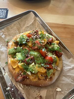 Baked pita with sweet potato hummus, avocado and cherry tomatoes  at Balans Bistro in Bratislava