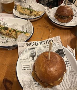 christmas specials — "ciganska pecene" seitan burger and "lokse" (potato pancake) with vegan bryndza cheese and tofu bacon bits  at Balans Bistro in Bratislava