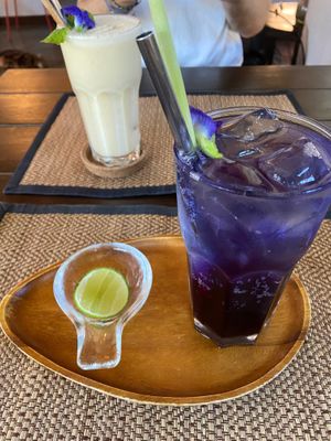 Butterfly pea soda and banana smoothie in the background  at Reform Kafe in Chiang Mai