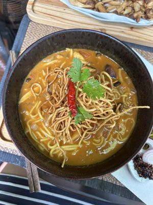 khao soi - northern thai noodle soup with a coconut broth and crispy noodles on top  at Reform Kafe in Chiang Mai