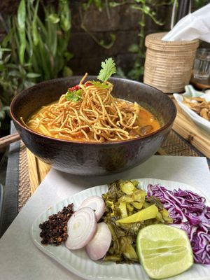khao soi - northern thai noodle soup with a coconut broth and crispy noodles on top  at Reform Kafe in Chiang Mai