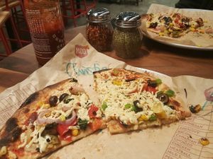Toppings are under the cheeze at Mod Pizza in Eugene